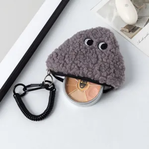 Macro detail of gray fuzzy onigiri shaped coin purse showing inner storage for cosmetics