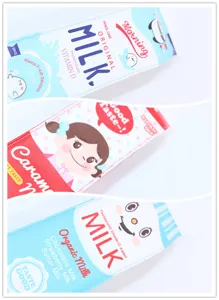 Close-up detail of cute cartoon milk carton pencil cases in various flavors and colors.