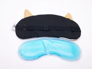 Detailed view of cat-themed sleep mask with detachable blue cooling gel pad.