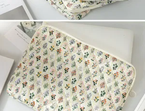 Floral quilted laptop sleeve showing a white laptop partially inside the protective case.