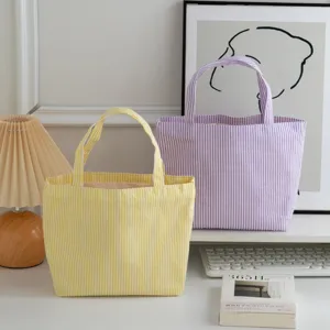 Two retro striped canvas tote bags in yellow and purple for summer daily lifestyle