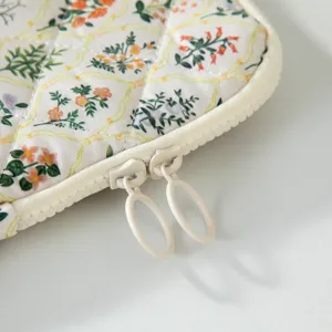 Floral quilted tablet laptop sleeve featuring elegant dual ring zippers for daily commute.