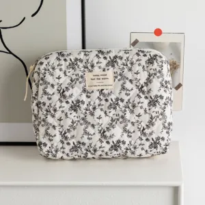 Close-up of quilted floral cosmetic bag with minimalist label detail