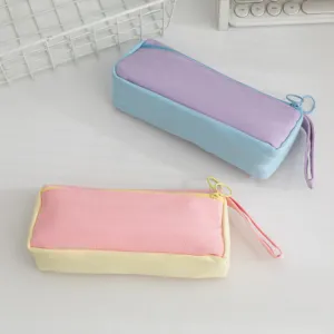 Close-up detail of two high-capacity pastel canvas pencil cases in aesthetic color block