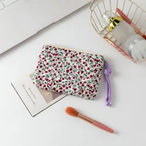 Detalle de un neceser de flores acolchado con tirador de borla morada