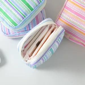 Detail view of portable striped seersucker pouch showing its internal storage space.