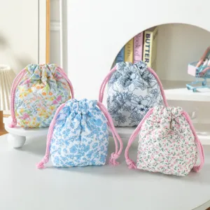 Group of quilted floral drawstring storage bags in various colorful patterns.
