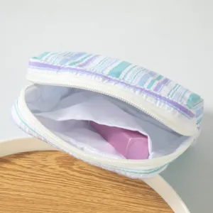 Detailed close-up of portable seersucker striped storage pouch showing interior space