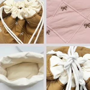 Detailed macro view of quilted bow embroidery and thick cotton drawstring mechanism