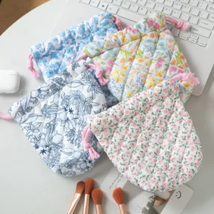 Colorful quilted floral drawstring storage pouches for portable makeup organization