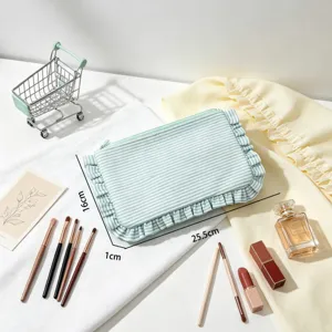 Detailed macro shot of the seersucker striped ruffled makeup bag with size annotations.