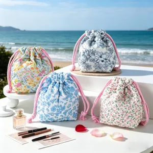 Four quilted floral drawstring makeup pouches displayed on a sunny beach background scene