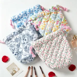 Collection of variety quilted floral drawstring makeup bags with brushes and petals