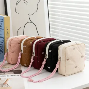 Quilted bow makeup bag collection in multiple colors for travel organizing