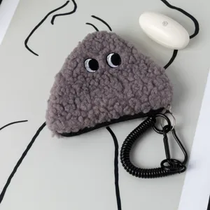 Close-up of gray plush rice ball coin purse with cute eye embroidery and spiral keychain.