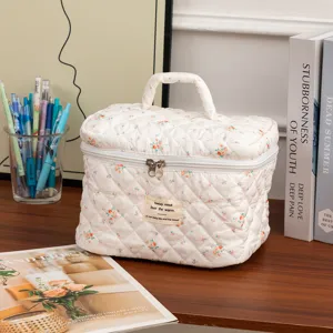 Cozy desk setting featuring a floral quilted cotton makeup bag with handle and zipper