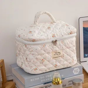 Close-up of a floral quilted cotton makeup bag organizer on a desk setting