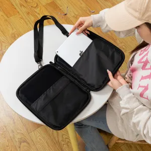 Interior view of black tablet shoulder bag showing storage pockets for iPad and accessories