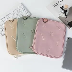Detailed view of three pastel colored protective laptop and tablet storage sleeves