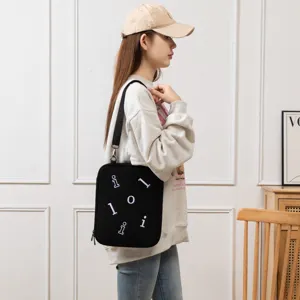Cross-body laptop sleeve for iPad 11 and Air 13.3 inch shown with a model in a room