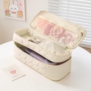 Detailed interior view of quilted heart pattern travel storage bag for hair dryer tools