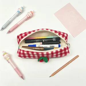 Detail view of red checkered pencil pouch showing high capacity with various stationery