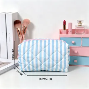 Blue and white striped quilted cosmetic bag showing dimensions of 18cm length and 10cm height.