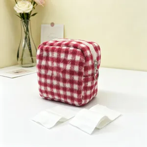Stylish red and white checkered plush cosmetic storage pouch with a convenient ring zipper