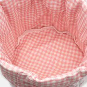 Close-up of the interior quilted lining of a pink checkered fabric storage basket