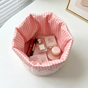 Close-up of pink gingham quilted storage basket filled with cosmetic items