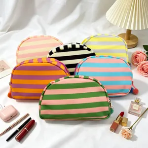 Variety of colorful striped shell-shaped cosmetic bags with dopamine aesthetic style