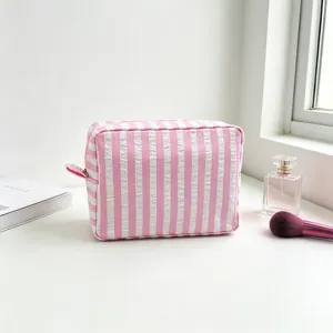 Pink seersucker striped makeup bag for travel storage and portable toiletry organization
