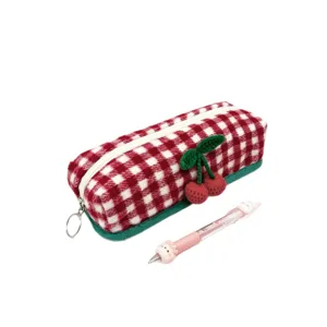 Large capacity checkered wool pencil case with cute cherry charm on white background.