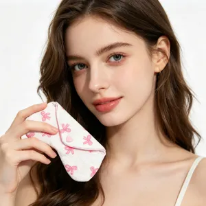 Primer plano de una bonita funda de gafas con lazos rosas y botón en forma de corazón