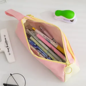 Interior detail of pink canvas pencil case showing large storage capacity for school pens