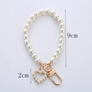 Detailed view of pearl keychain with heart pendant showing 9cm and 2cm dimensions