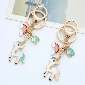 Detail of cute rainbow unicorn keychains with pastel enamel charms and gold-tone clasps.
