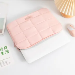 Minimalist pink quilted 14-inch laptop sleeve with protective padded design and soft inner