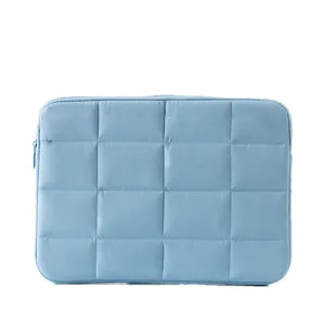 Sleek light blue 14-inch laptop sleeve featuring a minimalist quilted grid pattern design
