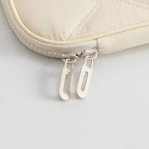 Macro detail showing the durable double zipper and stitching on a cream tablet sleeve