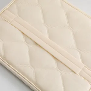 Close-up of beige hexagonal quilted texture on 11-inch tablet protective sleeve