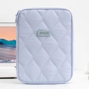Front view detail of lavender quilted 11-inch tablet sleeve on a white office desk.
