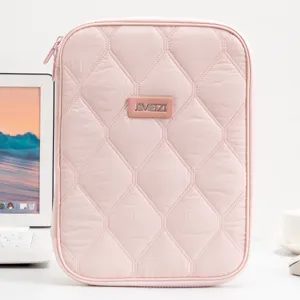 Minimalist quilted pink tablet sleeve for 11-inch iPad shown in a bright office setup.