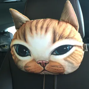 Detail view of a realistic 3D printed ginger cat headrest neck pillow on a car seat