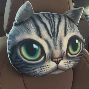 Detailed view of a realistic 3D cat head car neck pillow on a brown leather seat