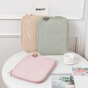 Detailed view of three pastel-colored 11 to 13.3 inch iPad laptop sleeves on a table