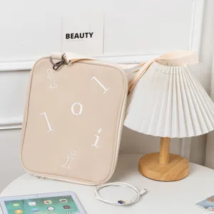 Beige crossbody laptop sleeve for iPad and 13.3-inch tablets with embroidered letters