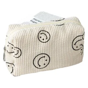 Neceser grande de pana crema con bonitos estampados negros de caras sonrientes