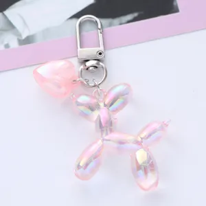 Close-up of pink iridescent balloon dog keychain featuring a cute heart charm detail