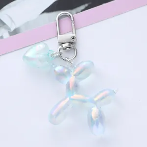 Detailed close-up of an iridescent balloon dog keychain with a matching heart charm